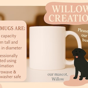 a black dog sitting next to a white coffee mug