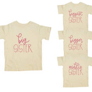 Big Sister shirt / Natural Tshirt , script, medium pink writing / big sister announcement. middle sister, bigger sister, biggest sister
