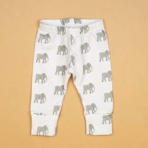 May include: White baby leggings with a gray elephant print.