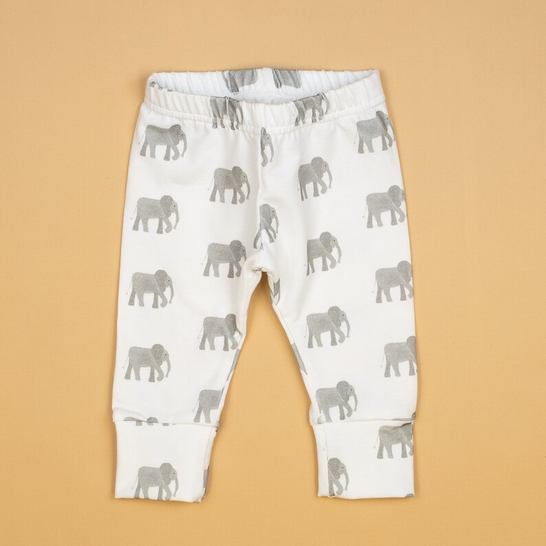 May include: White baby leggings with a gray elephant print.