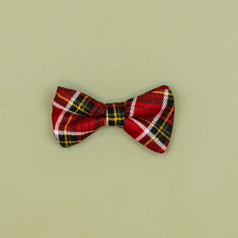 May include: A red, black, and white plaid bow tie.