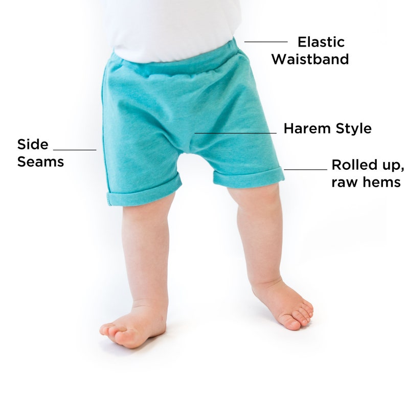 May include: Teal blue baby shorts with an elastic waistband, harem style, and rolled up raw hems.