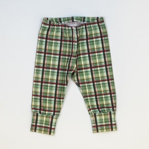 May include: Green, red, and white plaid leggings with cuffed ankles.