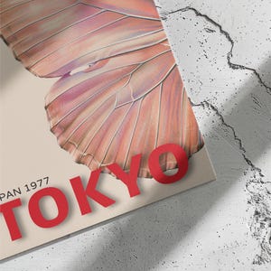 May include: A vintage poster with a pink butterfly and the text "TOKYO" in red letters. The poster also includes the text "PAN 1977".