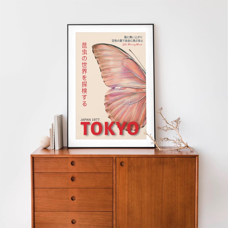 May include: A vintage poster with a pink butterfly wing design. The poster has the text "昆虫の世界を探検する" in Japanese, which translates to "Explore the world of insects". The poster also has the text "JAPAN 1977" and "TOKYO" in red.