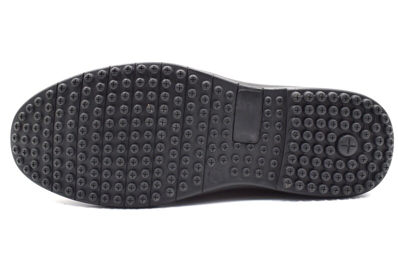 May include: Black rubber shoe sole with a textured pattern of small dots and a larger plus sign.
