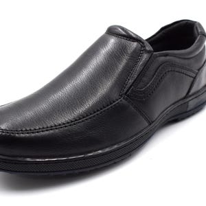 May include: Black leather slip-on shoes with a smooth finish and a rubber sole.