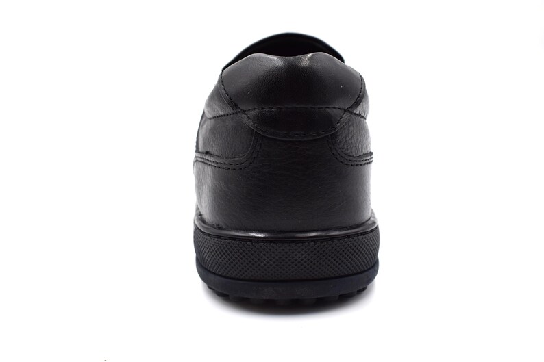 May include: Black leather slip-on shoes with a textured sole.