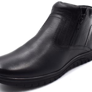 May include: Black leather ankle boots with a side zipper and a textured rubber sole.
