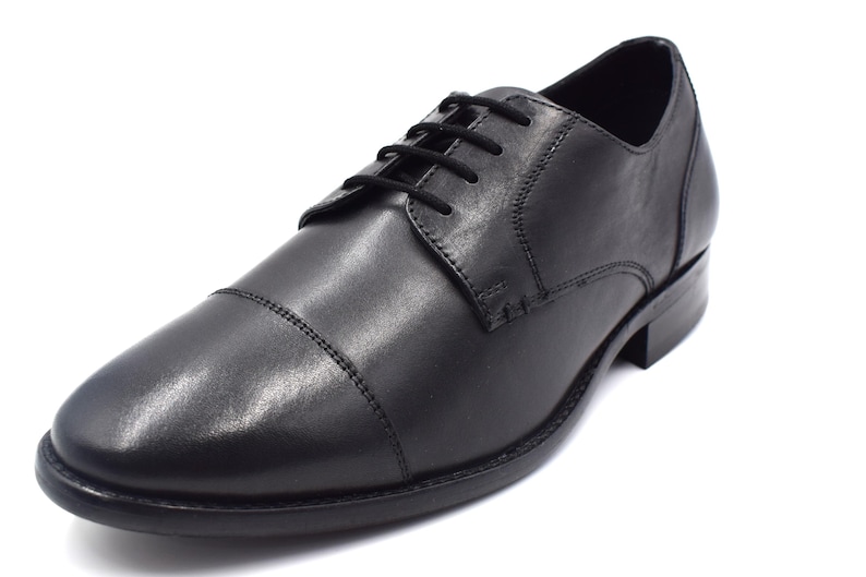 May include: Black leather lace-up dress shoes with a cap toe design.