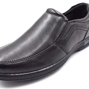 May include: Black leather slip-on shoes with a textured sole.