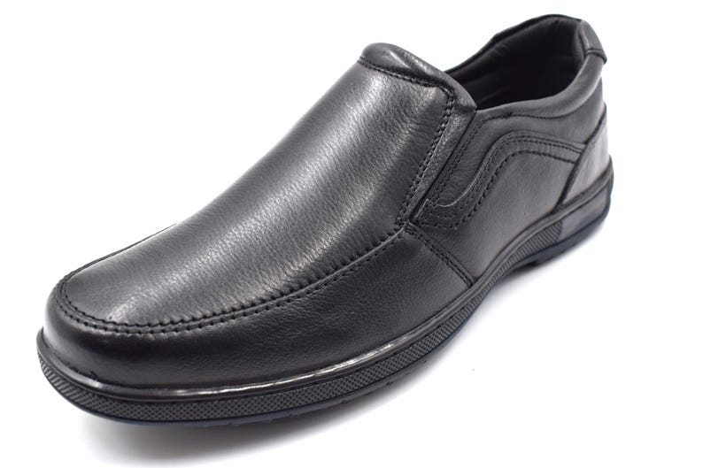 May include: Black leather slip-on shoes with a textured sole.
