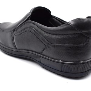 May include: Black leather slip-on shoe with a rubber sole.