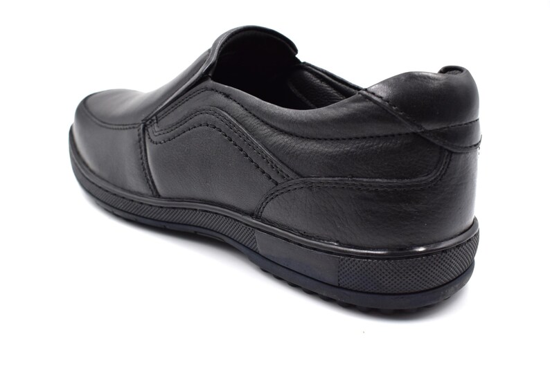 May include: Black leather slip-on shoe with a rubber sole.