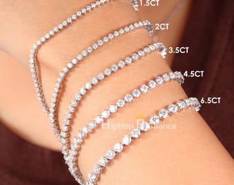 May include: Several diamond tennis bracelets of varying carat weights are displayed. The bracelets are set with round, clear diamonds. The image includes text that reads "Lab Grown Diamonds".