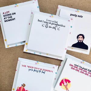May include: A set of five colorful sticky note pads with different quotes and illustrations. The quotes include "A lot going on at the moment", "I cry a lot but I am so productive it's an art", "You need to calm down you're being too bad", "Posty note", and "And I'm just like oh-oh, oh-oh, oh-oh, oh-oh".
