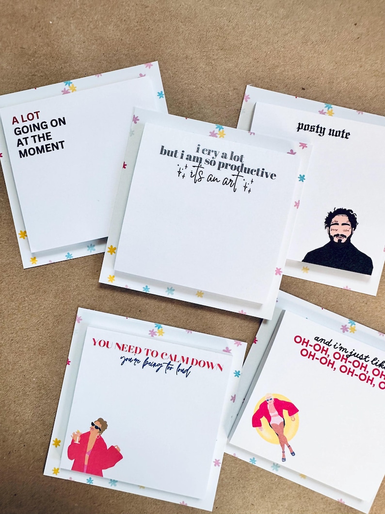 May include: A set of five colorful sticky note pads with different quotes and illustrations. The quotes include "A lot going on at the moment", "I cry a lot but I am so productive it's an art", "You need to calm down you're being too bad", "Posty note", and "And I'm just like oh-oh, oh-oh, oh-oh, oh-oh".
