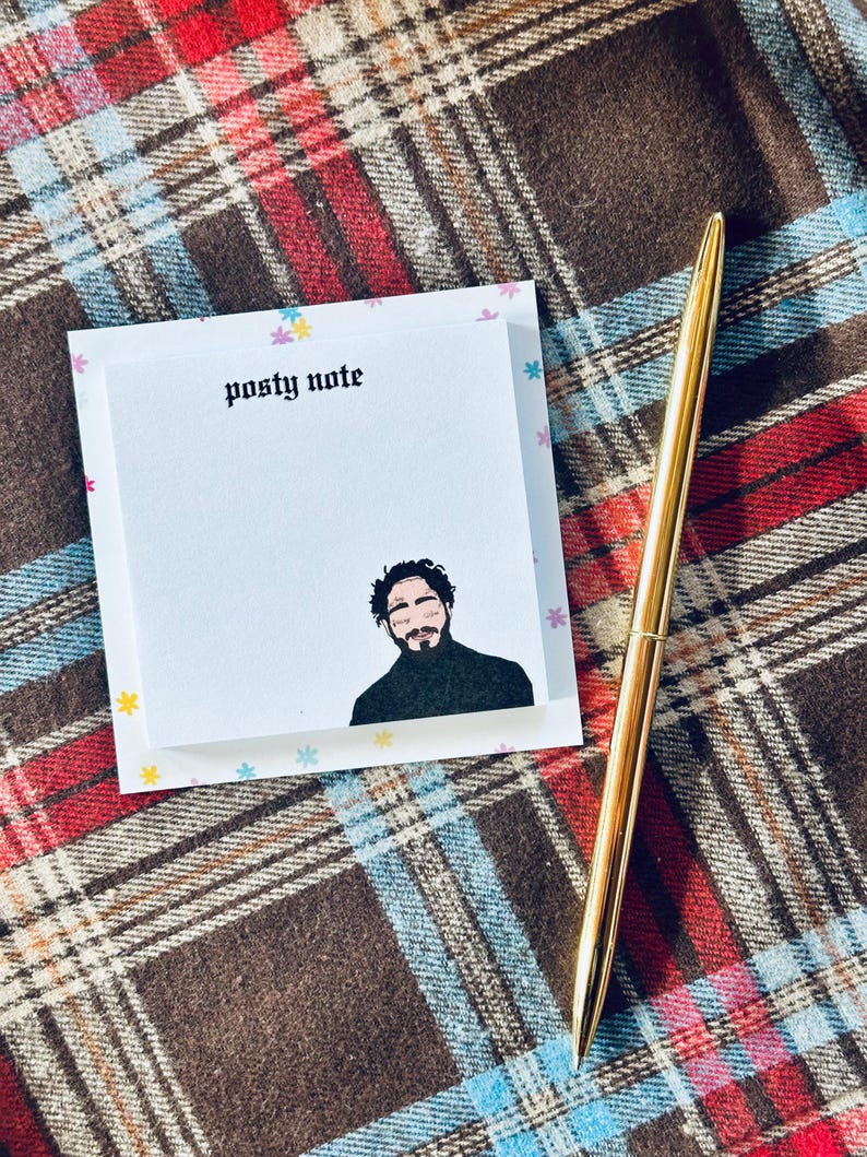 May include: A white notepad with a black and white illustration of a person with a black turtleneck. The notepad has a colorful background with small stars and the text "posty note" at the top.