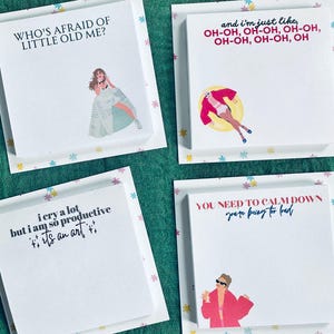 May include: Four white sticky note pads with colorful floral borders and illustrations of a woman. The text on the pads reads "Who's afraid of little old me?", "i cry a lot but i am so productive it's an art", "and i'm just like, OH-OH, OH-OH, OH-OH, OH-OH, OH-OH, OH", and "YOU NEED TO CALM DOWN you're being too loud".