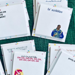 May include: A set of colorful sticky notes with various quotes and illustrations. The notes feature a pink and blue floral pattern and include quotes like "Who's afraid of lite?" and "and I'm just like, oh-oh, oh-oh, oh-oh, oh-oh, oh-oh, oh".