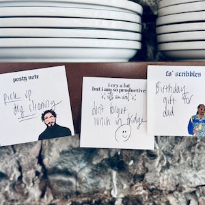 May include: Three sticky notes with handwritten messages and cartoon images. The first note says "Pick up dry cleaning". The second note says "I cry a lot but I am so productive it's an art". The third note says "Birthday gift for dad".