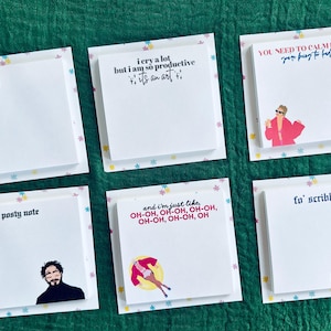 May include: Six colorful sticky note pads with different designs and text. The text on the pads includes "A lot going on at the moment", "I cry a lot but I am so productive, it's an art", "You need to calm down, you're being to hard", "Posty note", "And I'm just like, oh-oh, oh-oh, oh-oh, oh-oh, oh-oh, oh", and "Fo' scribbles".