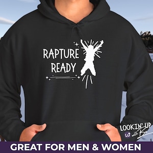 May include: Black hoodie featuring the text "Rapture Ready" and a white graphic of a person jumping. The hoodie also has the text "LOOKIN' UP with Bri" and "GREAT FOR MEN & WOMEN".