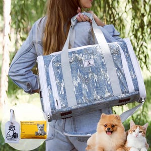 May include: Blue pet carrier with a sequined design, white zippers, and gray straps. Includes a matching tag and pet waste bags. A Pomeranian dog and a cat are in the foreground.
