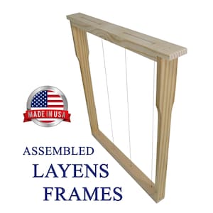 May include: Assembled Layens frames made in the USA. The wooden frame is light brown with three vertical wires. The frame has a rectangular shape with a top and bottom piece connected by two side pieces.