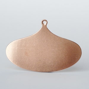 May include: A copper-colored, teardrop-shaped ornament with a small loop at the top for hanging. The surface has a slightly textured appearance. The ornament is likely for holiday or seasonal decor.