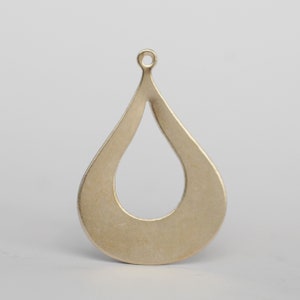 May include: A gold-toned metal pendant shaped like a teardrop with a cutout in the center. The pendant has a loop at the top for attaching to a chain or cord.