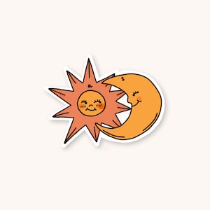 May include: A sticker featuring a cartoon sun and moon. The sun is orange with a smiling face and spiky rays. The moon is crescent-shaped, also orange, and has a smiling face. The sticker has a white border and is on a cream background.