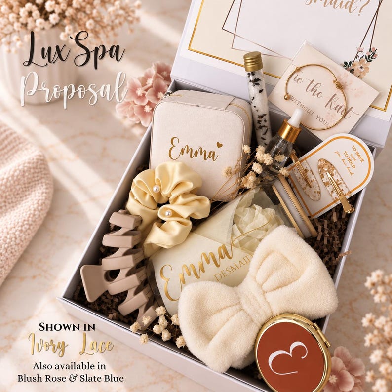May include: A gift box containing a personalized jewelry case with the name Emma, a cream scrunchie with pearls, a beige hair claw, a glass vial of bath salts, a dropper bottle, a gold bangle, hair clips, a plush bow headband, and a compact mirror.