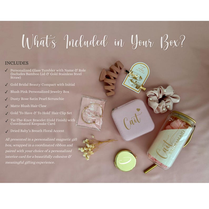 May include: A gift set including a glass tumbler with a bamboo lid and gold straw, a blush pink jewelry box labeled Cait, a dusty rose pearl scrunchie, a matte blush hair claw, a gold hair clip set, a gold bracelet, and dried flowers.