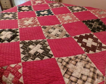 May include: A red and white patchwork quilt with a variety of patterns, including plaid, diamonds, and squares.