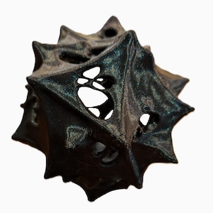 May include: A black, 3D printed, geometric object with a star-shaped design and intricate cutouts. The object has a textured, iridescent surface.