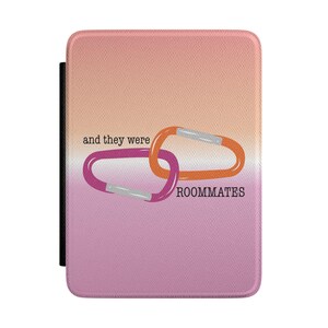 May include: A tablet case with a gradient background of pink and orange. The case features two interlocking carabiners in pink and orange with silver accents. The text "and they were ROOMMATES" is printed below the carabiners.