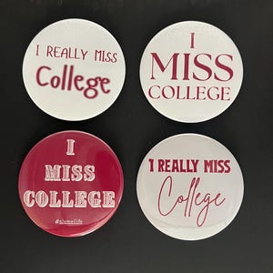May include: Four circular pin-back buttons with maroon text on white or maroon backgrounds. Two buttons read I REALLY MISS College, one reads I MISS COLLEGE, and one reads I MISS COLLEGE with #alumnilife at the bottom in a maroon and white design.