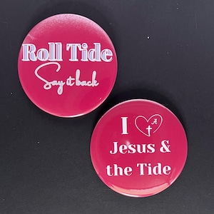 May include: Two red round buttons with white text. The first button says "Roll Tide Say it back". The second button says "I ♥ A+ Jesus & the Tide".