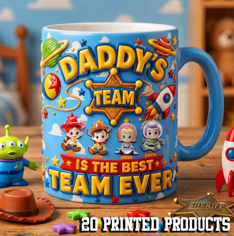 May include: A blue ceramic mug with a handle, featuring the text "DADDY'S TEAM IS THE BEST TEAM EVER" and cartoon characters. The mug has a blue handle and is decorated with stars, a rocket, and a sheriff's badge. Additional toy figures are visible.