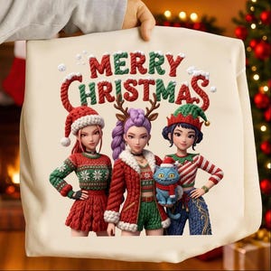 May include: A cream-colored tote bag featuring the text "MERRY CHRISTMAS" in red and green, with three cartoon figures wearing Christmas-themed outfits. One figure holds a blue cat. The bag is held by a person.