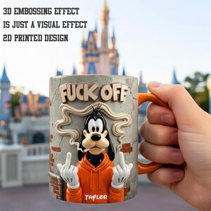 May include: A ceramic mug with an orange handle and a design featuring a cartoon dog giving the middle finger. The mug has the words "FUCK OFF" and the name "TAYLOR" printed on it. The mug is orange, gray, and white.