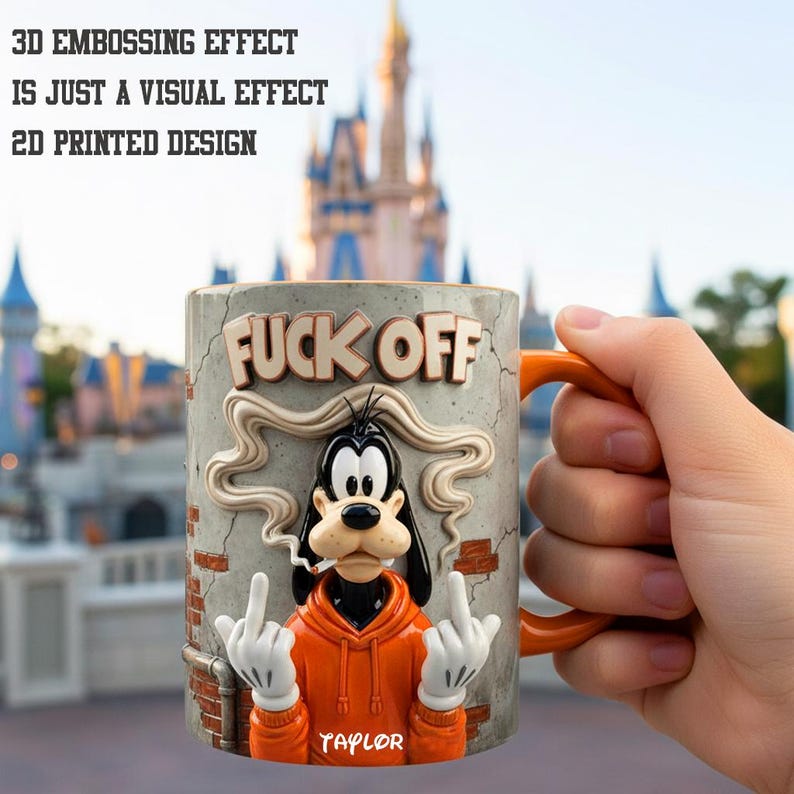 May include: A ceramic mug with an orange handle and a design featuring a cartoon dog giving the middle finger. The mug has the words "FUCK OFF" and the name "TAYLOR" printed on it. The mug is orange, gray, and white.