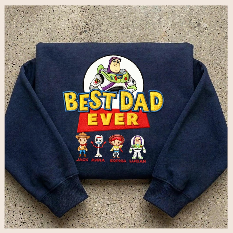May include: Navy blue sweatshirt featuring a graphic of Buzz Lightyear and the phrase "BEST DAD EVER" in yellow and red. Below the text are cartoon character illustrations. The names Jack, Anna, Sophia, and Lucian are printed below the characters.