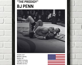 May include: Black and white framed print featuring a mixed martial arts fight scene. The print includes the text "THE PRODIGY" and "BJ PENN". Additional text details height, weight, reach, stance, date of birth, and record. An American flag is also displayed.