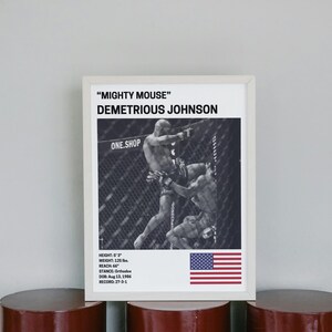 a framed poster of Demetrious Johnson, a professional mixed martial artist, with a focus on his fighting stance and technique.