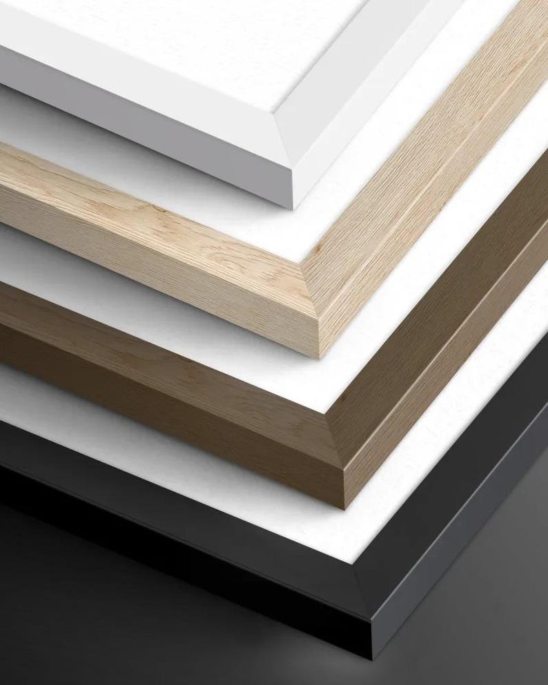 a close-up view of a collection of wooden frames in various colors and finishes, including white, light brown, and dark brown.