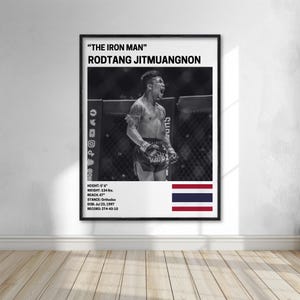 The image is a framed poster featuring a black and white photograph of a male fighter, likely Rodtang Jitmuanon, who is known for his fighting skills.