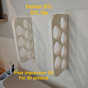 May include: Two off-white, wall-mounted shelves with oval cutouts. The shelves are mounted on a white wall. Text in yellow reads "Fichier STL STL file" and "Pour impression 3D For 3D printind".