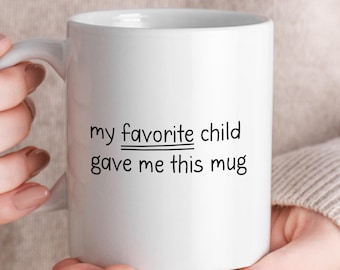 May include: White ceramic mug with black text that reads "my favorite child gave me this mug". The word "child" is underlined twice.
